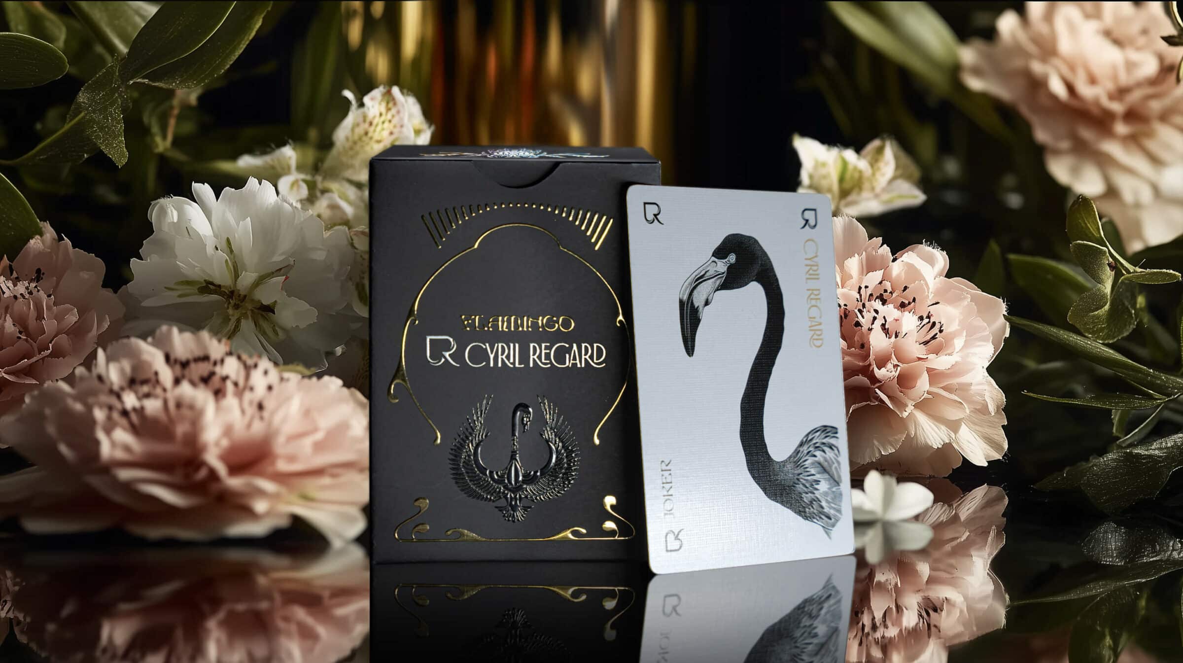 Premium Flamingo playing cards by Cyril Regard — the black and gold case and the flamingo card